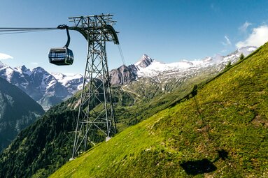 3K K-onnection gondola at Kitzsteinhorn with high, partly snow-covered mountain peaks in the background. | © Kitzsteinhorn 