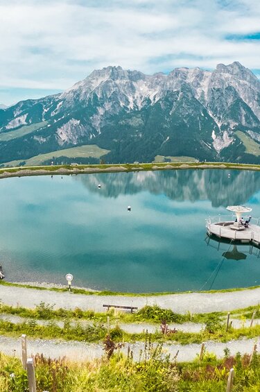 Stille Wasser at Asitz in Leogang with mountain lake, jetty and paths against a mountain backdrop. | © Michael Geißler