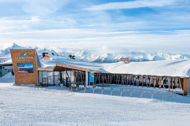 Panoramarestaurant Franzl auf der Schmittenhöhe vor einem Panorama verschneiter Berggipfel. | © Schmittenhöhebahn AG
